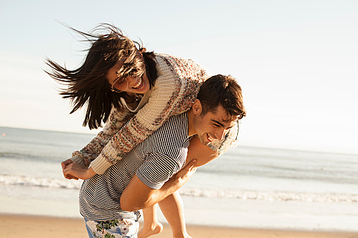 Young couple fooling around on beach